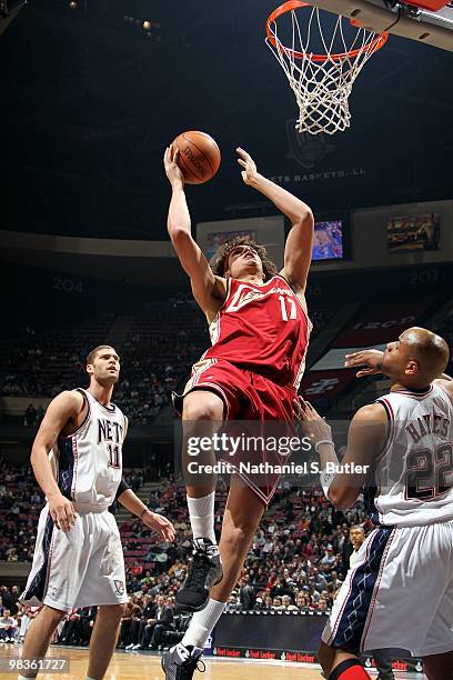 Anderson Varejao of the Cleveland Cavaliers shoots a layup against Brook Lopez and Jarvis Hayes of the New Jersey Nets during the game at the IZOD...