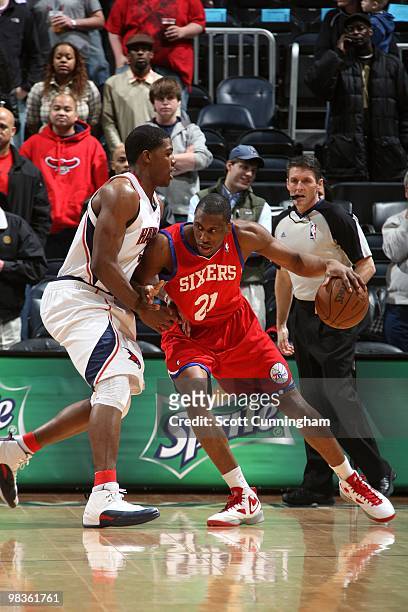 Thaddeus Young of tte Philadelphia 76ers posts up against Joe Johnson of the Atlanta Hawks during the game at Philips Arena on March 3, 2010 in...