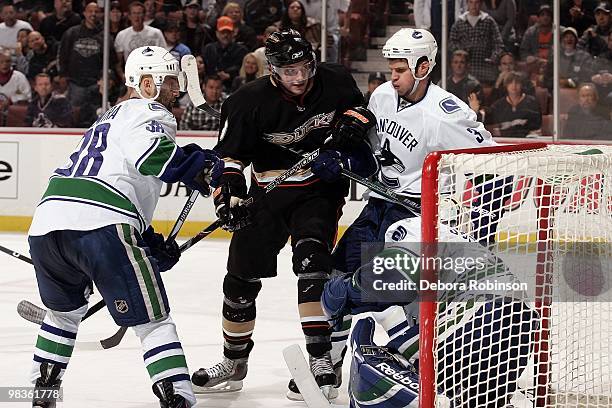 Bobby Ryan of the Anaheim Ducks battles in front of the net against Andrew Raycroft, Kevin Bieksa and Pavol Demitra of the Vancouver Canucks during...