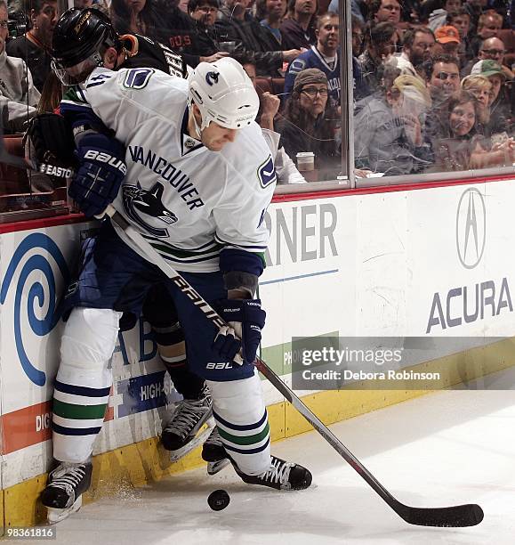 Matt Beleskey of the Anaheim Ducks battles for the puck alongside the boards against Andrew Alberts of the Vancouver Canucks during the game on April...