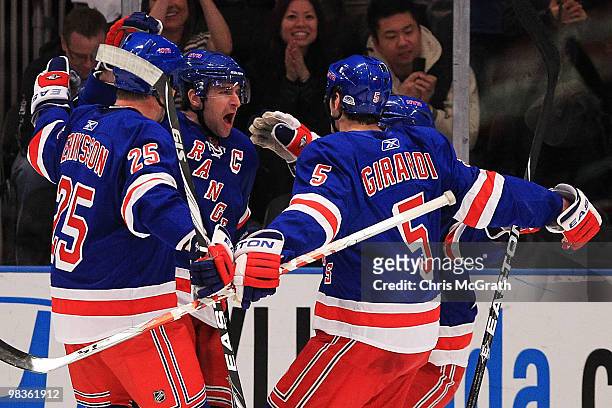 Chris Drury of the New York Rangers celebrates scoring a goal with team mates Anders Eriksson and Dan Girardi of the New York Rangers against the...