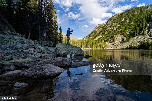 fly fishing on mountain lake - colorado mountains stock pictures, royalty-free photos & images