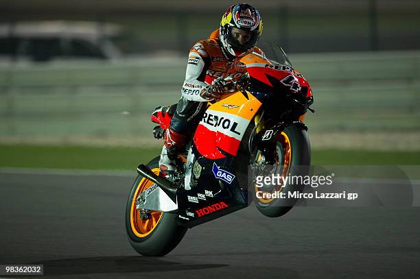 Andrea Dovizioso of Italy and Repsol Honda Team lifts the front wheel during the free practice sessione during the official photo session at Losail...