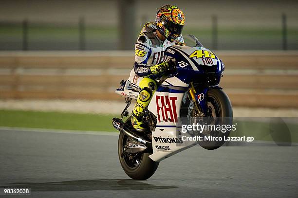 Valentino Rossi of Italy and Fiat Yamaha Team lifts the front wheel during the free practice sessione during the official photo session at Losail...