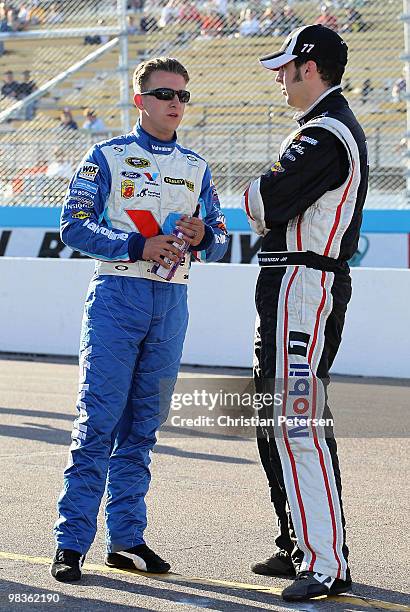 Allmendinger, driver of the Valvoline Ford, talks with Sam Hornish Jr, driver of the Mobil 1 Dodge, on from the grid during qualifying for the NASCAR...