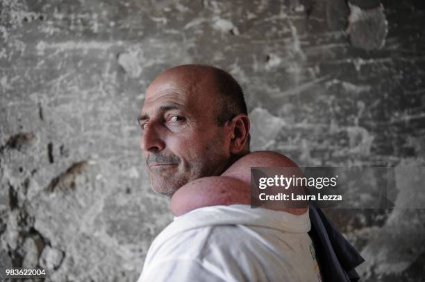 Man poses for a photo just after the annual Festa dei Gigli with his shoulder strain called 'patana' or 'pataniello' caused by having carried a...