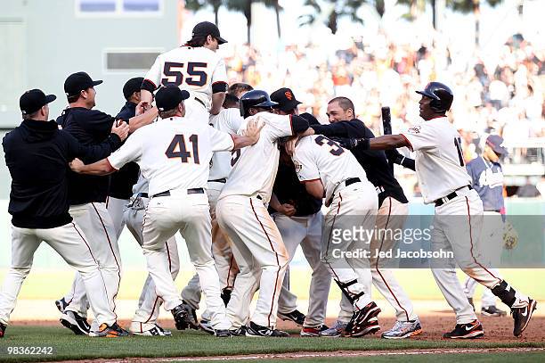 Aaron Rowand of the San Francisco Giants celebrates with teammates after hitting the game winning single in the 13th inning against the Atlanta...