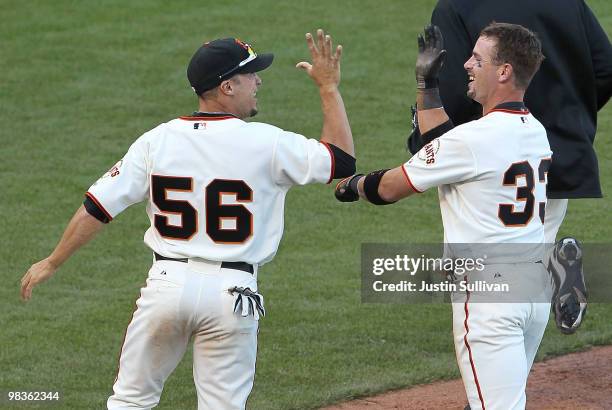 Aaron Rowand of the San Francisco Giants is congratulated by Andres Torres after driving in the winning run during the thirteenth inning against the...