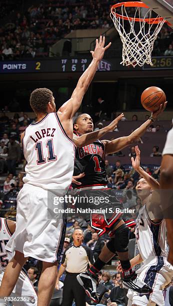 Derrick Rose of the Chicago Bulls shoots against Brook Lopez of the New Jersey Nets on April 9, 2010 at the IZOD Center in East Rutherford, New...