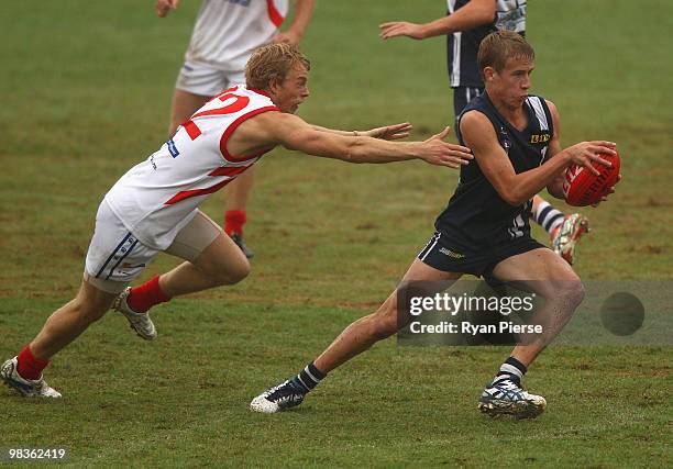David Peel of the Falcons is tackled by Darcy Thorpe of the Power during the round three TAC Cup match between the Geelong Falcons and the Gippsland...