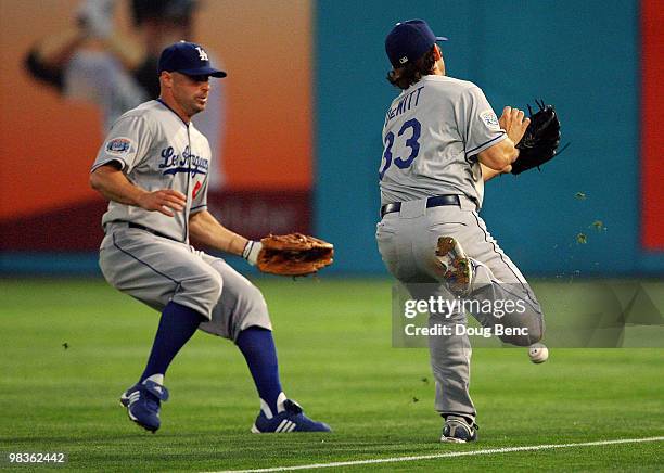 Second baseman Blake DeWitt of the Los Angeles Dodgers drops a looped drive after nearly colliding with right fielder Reed Johnson while taking on...