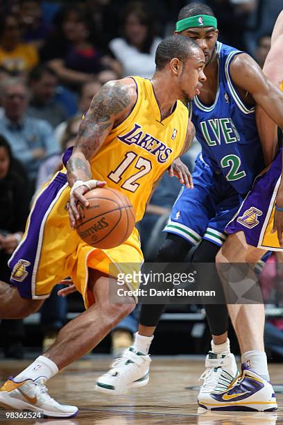 Shannon brown of the Los Angeles Lakers moves the ball against Corey Brewer of the Minnesota Timberwolves during the game on April 9, 2010 at the...