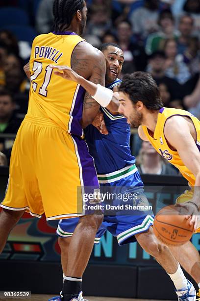Wayne Ellington of the Minnesota Timberwolves fights through a screen against Josh Powell Pau Gasol of the Los Angeles Lakers during the game on...