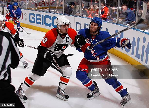 Brandon Prust of the New York Rangers skates against Mike Richards of the Philadelphia Flyers in the second period on April 9, 2010 at Madison Square...