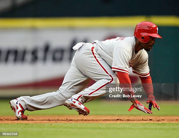 Jimmy Rollins of the Philadelphia Phillies dives back into first base at Minute Maid Park on April 9, 2010 in Houston, Texas.