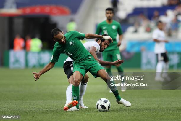 Abdullah Otayf of Saudi Arabia battles for possession with Marwan Mohsen of Egypt during the 2018 FIFA World Cup Russia group A match between Saudia...