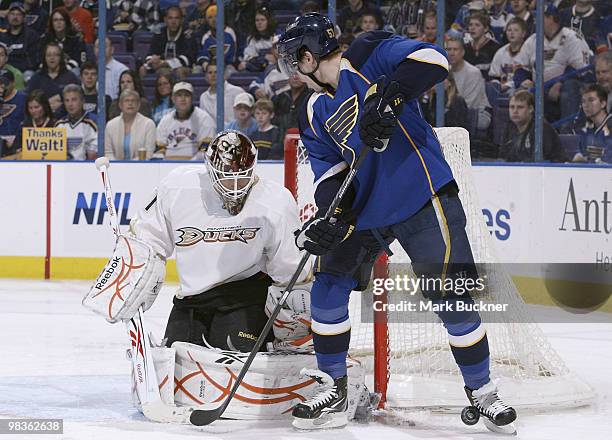 Curtis McElhinney of the Anaheim Ducks defends against David Perron of the St. Louis Blues on April 9, 2010 at Scottrade Center in St. Louis,...
