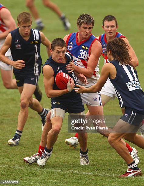 Devon Smith of the Falcons breaks through the pack during the round three TAC Cup match between the Geelong Falcons and the Gippsland Power at Queen...
