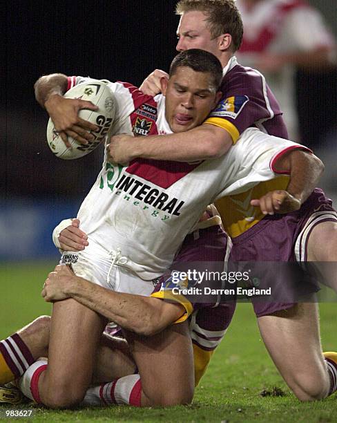 Lee Hookey of the Dragons is tackled by Darren Lockyer of the Broncos during the round ten NRL game between the Brisbane Broncos and the St George...