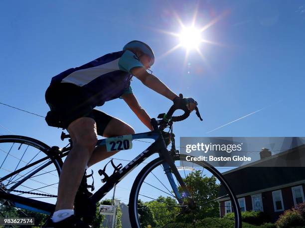 Ann Whaley-Tobin heads down her street for a bike ride in Canton, MA on June 20, 2018. As one failed drug trial after the next has dashed hopes for a...