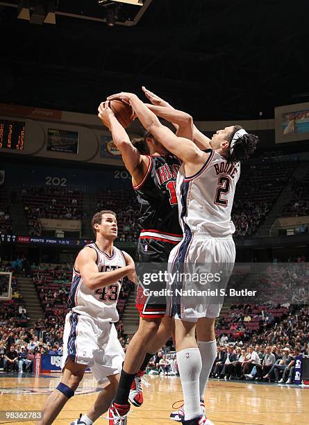 Josh Boone of the New Jersey Nets blocks against Joakim Noah of the Chicago Bulls on April 9, 2010 at the IZOD Center in East Rutherford, New Jersey....