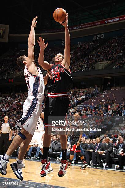 Joakim Noah of the Chicago Bulls shoots against Kris Humphries of the New Jersey Nets on April 9, 2010 at the IZOD Center in East Rutherford, New...
