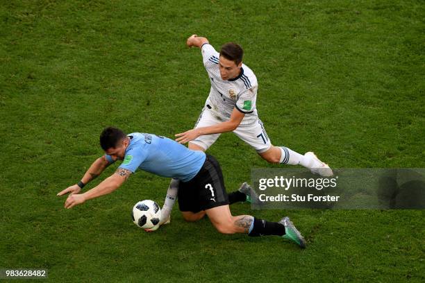 Daler Kuziaev of Russia fouls Cristian Rodriguez of Uruguay during the 2018 FIFA World Cup Russia group A match between Uruguay and Russia at Samara...