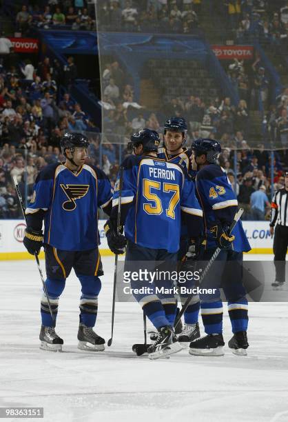 Eric Brewer of the St. Louis Blues is congratulated on a goal against the Anaheim Ducks by teammates Andy McDonald David Perron and Mike Weaver on...
