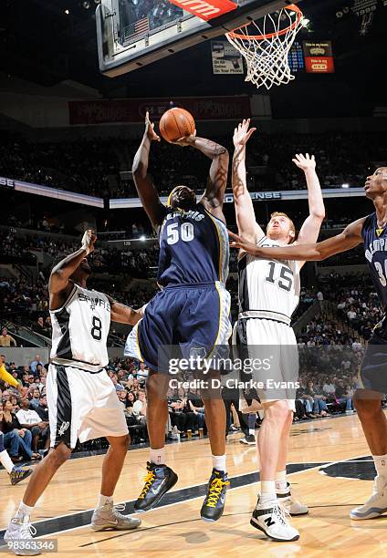 Zach Randolph of the Memphis Grizzlies shoots against Matt Bonner and Roger Mason, Jr. #8 of the San Antonio Spurs on April 9, 2010 at the AT&T...