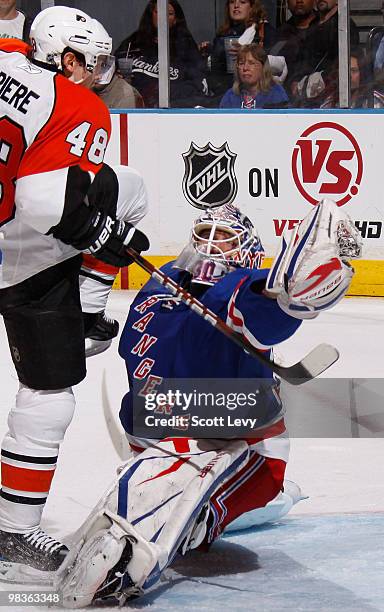 Henrik Lundqvist of the New York Rangers makes a third period save against Ian LaPerriere of the Philadelphia Flyers on April 9, 2010 at Madison...