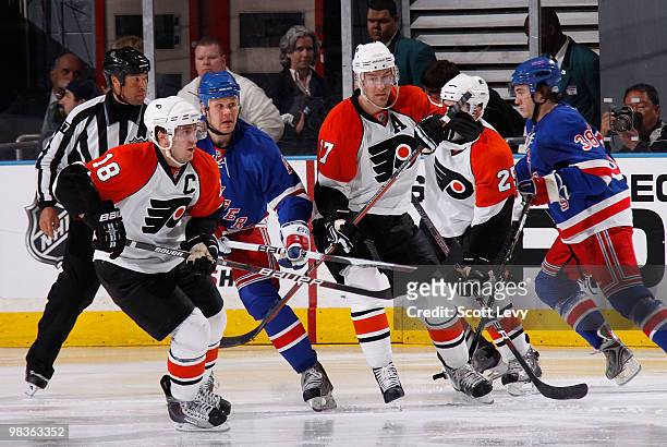 Olli Jokinen of the New York Rangers skates against Jeff Carter and Mike Richards of the Philadelphia Flyers in the third period on April 9, 2010 at...