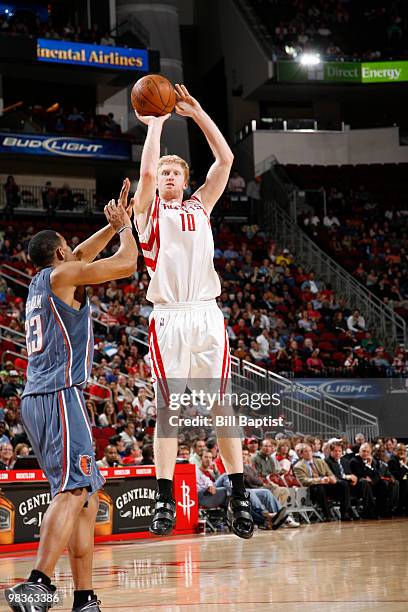 Chase Budinger of the Houston Rockets shoots the ball over Stephen Graham of the Charlotte Bobcats on April 9, 2010 at the Toyota Center in Houston,...