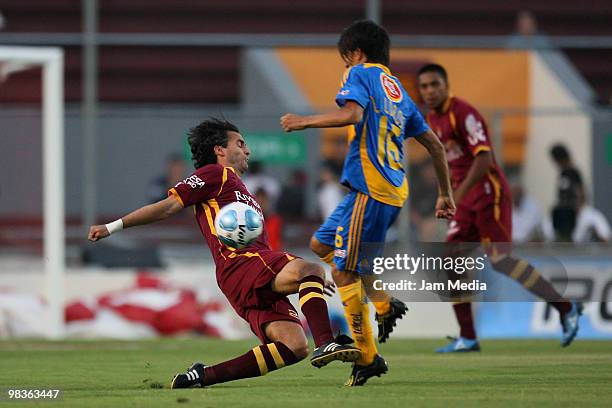 Juan Carlos Leano of Estudiantes fights for the ball with Lucas Lobos of Tigres during a match as part of the 2010 Bicentenary tournament at the 3 de...