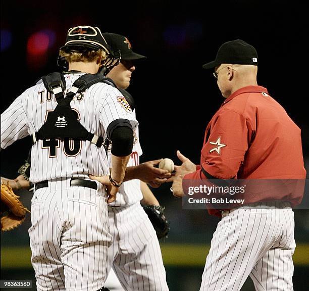 Houston Astros manager Brad Mills takes the ball from pitcher Bud Norris as he is removed fro the game in the third inning as catcher J.R.Towles...