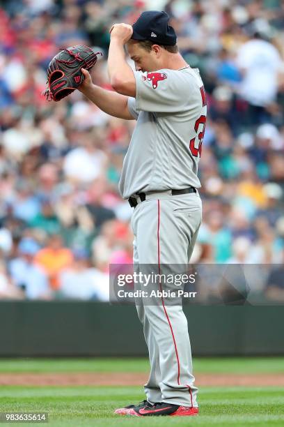 Steven Wright of the Boston Red Sox reacts after giving up a hit in the sixth inning against the Seattle Mariners during their game at Safeco Field...