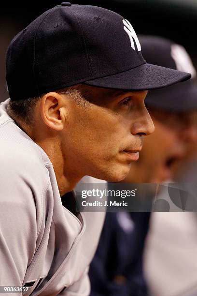 Manager Joe Girardi of the New York Yankees watches his team from the dugout against the Tampa Bay Rays during the game at Tropicana Field on April...