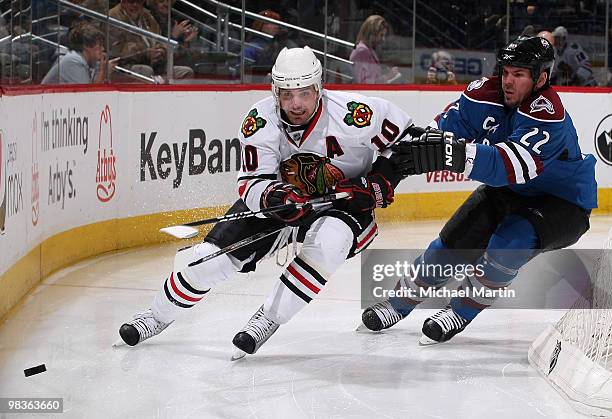 Scott Hannan of the Colorado Avalanche skates against Patrick Sharp of the Chicago Blackhawks at the Pepsi Center on April 9, 2010 in Denver,...