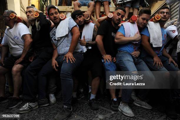 Men carry a 25-metre tall wood and papier-mache statue called 'giglio' during the annual Festa dei Gigli on June 25, 2018 in Nola, Italy. When St....