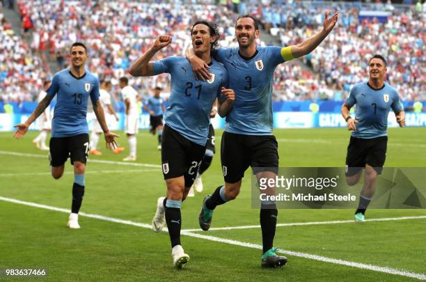 Edinson Cavani of Uruguay celebrates with teammate Diego Godin after scoring his team's third goal during the 2018 FIFA World Cup Russia group A...