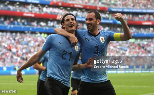 Edinson Cavani of Uruguay celebrates with teammate Diego Godin after scoring his team's third goal during the 2018 FIFA World Cup Russia group A...