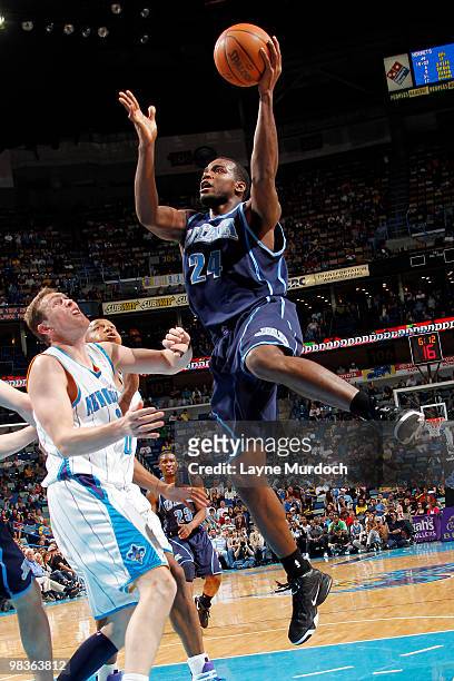 Paul Millsap of the Utah Jazz shoots over Darius Songaila of the New Orleans Hornets on April 9, 2010 at the New Orleans Arena in New Orleans,...