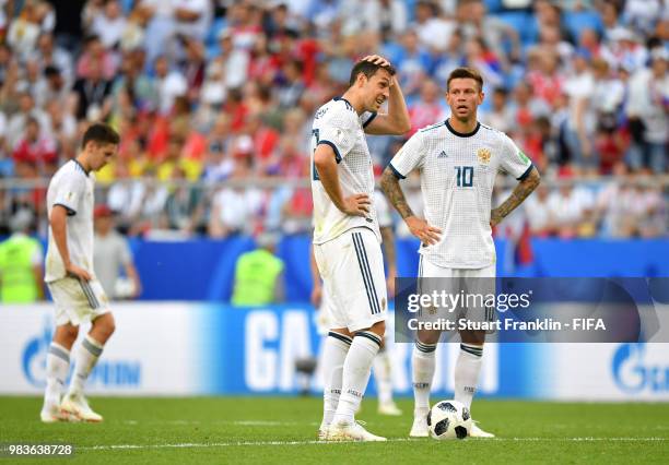 Artem Dzyuba and Fedor Smolov of Russia look dejected following Uruguay's third goal during the 2018 FIFA World Cup Russia group A match between...