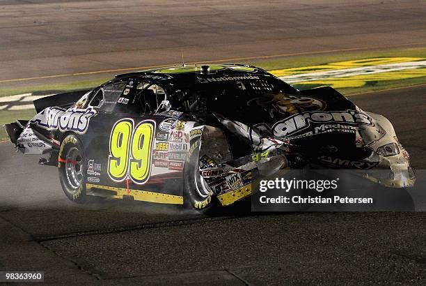 Trevor Bayne, driver of the Aaron's Dream Machine Toyota, drives his damaged car to the garage after a crash during the NASCAR Nationwide Series...