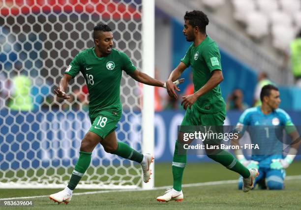 Salem Aldawsari of Saudi Arabia celebrates with teammate Hussain Almoqahwi after scoring his team's second goal during the 2018 FIFA World Cup Russia...