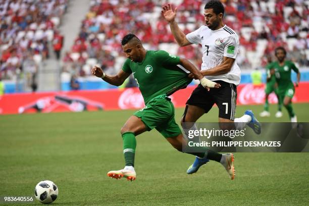 Saudi Arabia's forward Salem Al-Dawsari is held back by Egypt's defender Ahmed Fathi during the Russia 2018 World Cup Group A football match between...