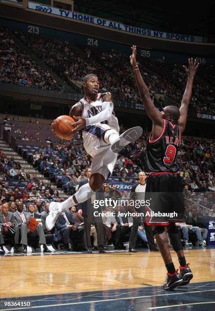 Terrence Williams of the New Jersey Nets passes against Luol Deng of the Chicago Bulls on April 9, 2010 at the IZOD Center in East Rutherford, New...