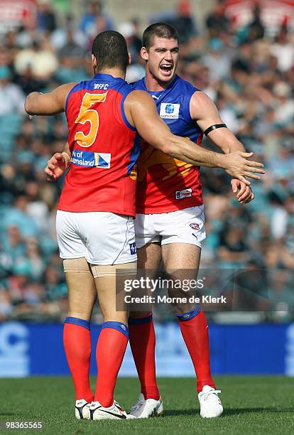 Jonathan Brown and Brendon Fevola of the Lions celebrate a goal during the round three AFL match between Port Adelaide Power and Brisbane Lions at...