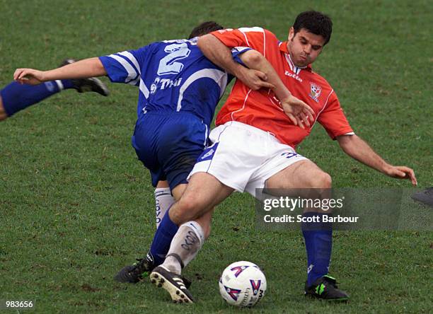 Aljosa Asanovic of Sydney United is tackled by Sebastian Sinozic of Sydney Olympic during the NSL match between Sydney United and Sydney Olympic...