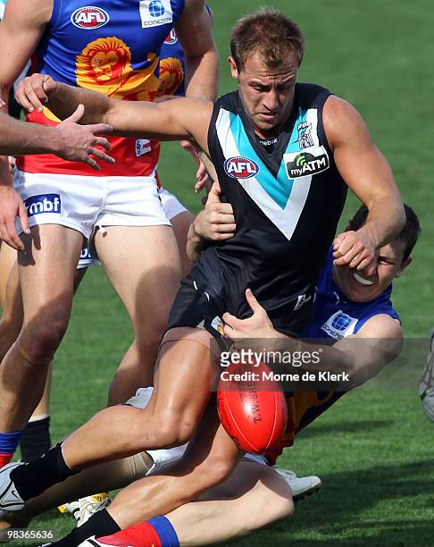 Matt Thomas of the Power is tackled during the round three AFL match between Port Adelaide Power and Brisbane Lions at AAMI Stadium on April 10, 2010...