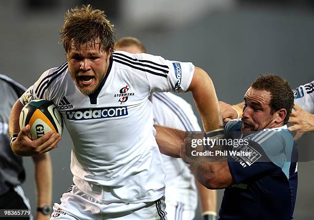 Duane Vermeulen of the Stomers is tackled by Alby Mathewson of the Blues during the round nine Super 14 match between the Blues and the Stormers at...